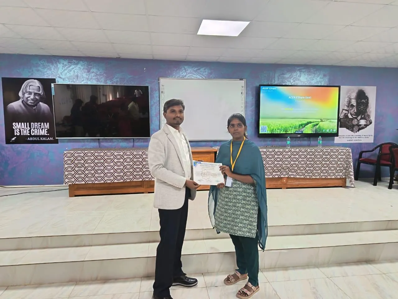 A student receiving a certificate from a trainer