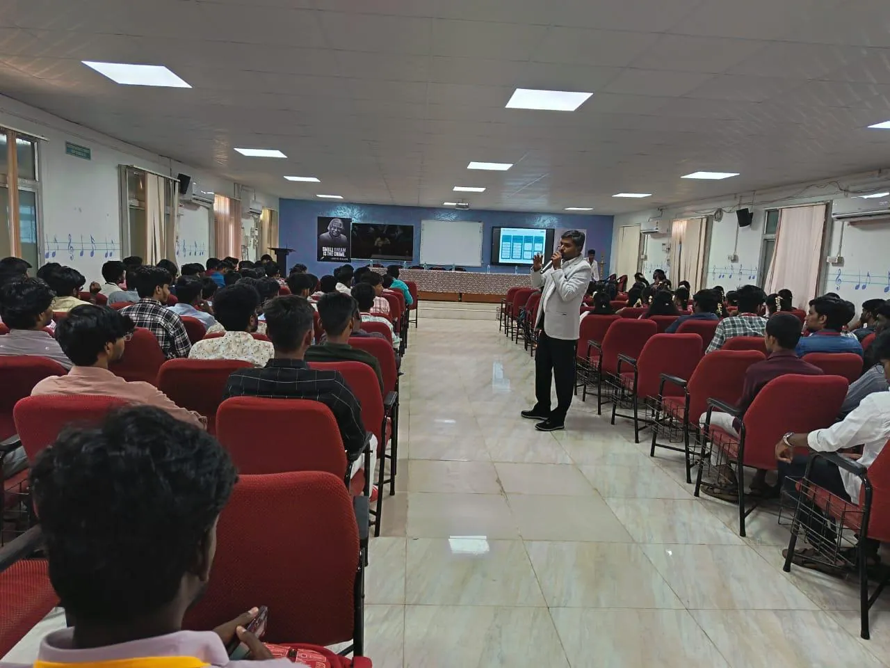 Trainer leading an interactive session with students in a lecture hall